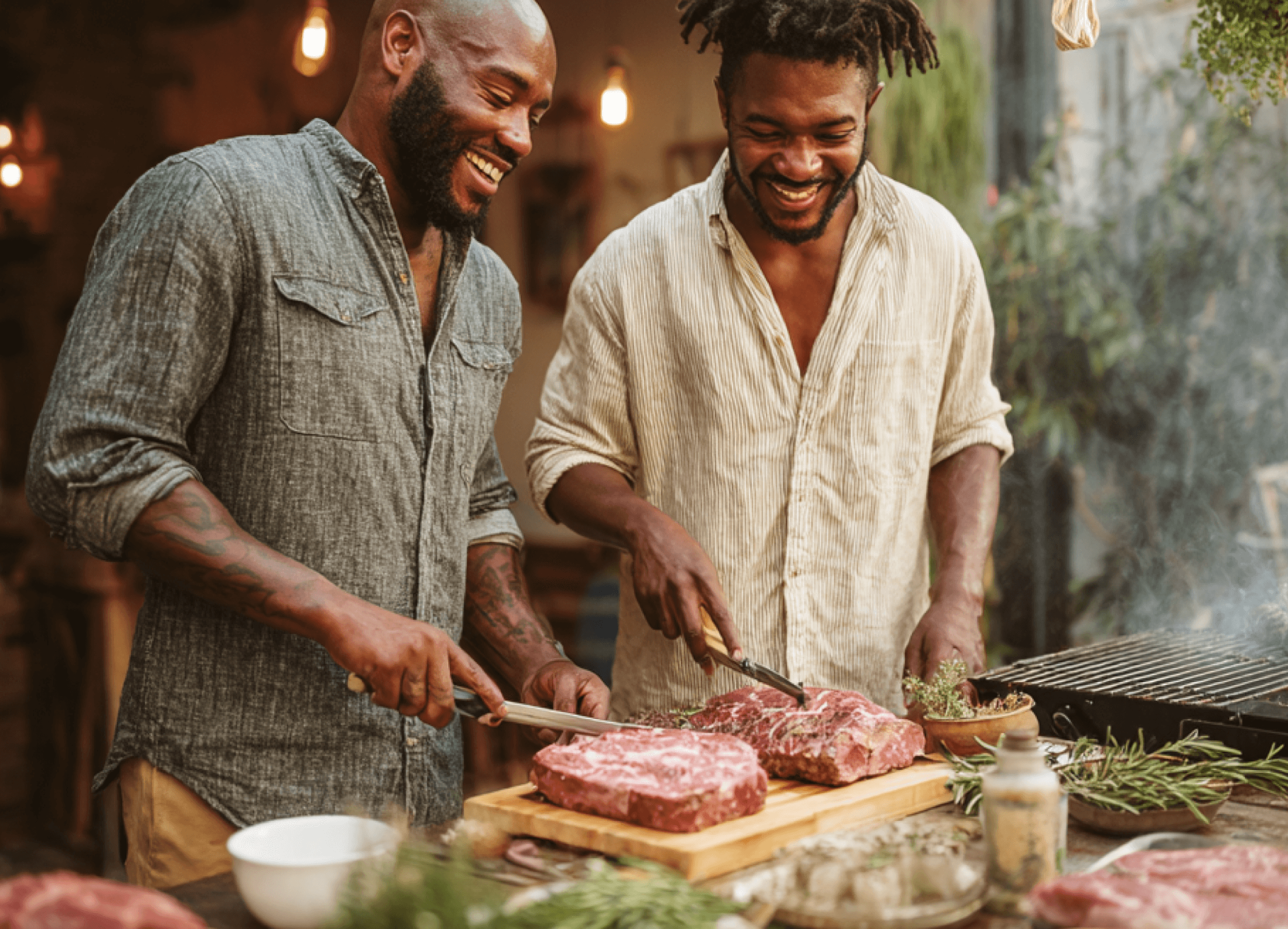 Two men braaing outside with good cuts of meat